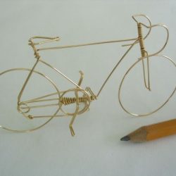 Bicycle is handmade from a single piece of wire, 2" high and 3" long. Bicycle is handmade from a single piece of wire, 2" high and 3" long.