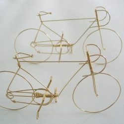Bicycle is handmade from a single piece of wire, 2" high and 3" long. Bicycle is handmade from a single piece of wire, 2" high and 3" long.