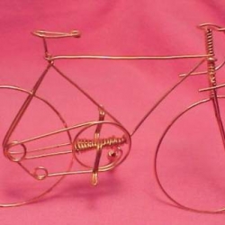 Bicycle is handmade from a single piece of wire, 2" high and 3" long. Bicycle is handmade from a single piece of wire, 2" high and 3" long.